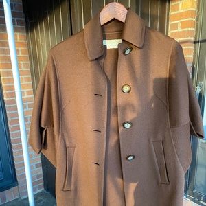 Micheal Kors Brown 50% Virgin wool. 50% Angora.